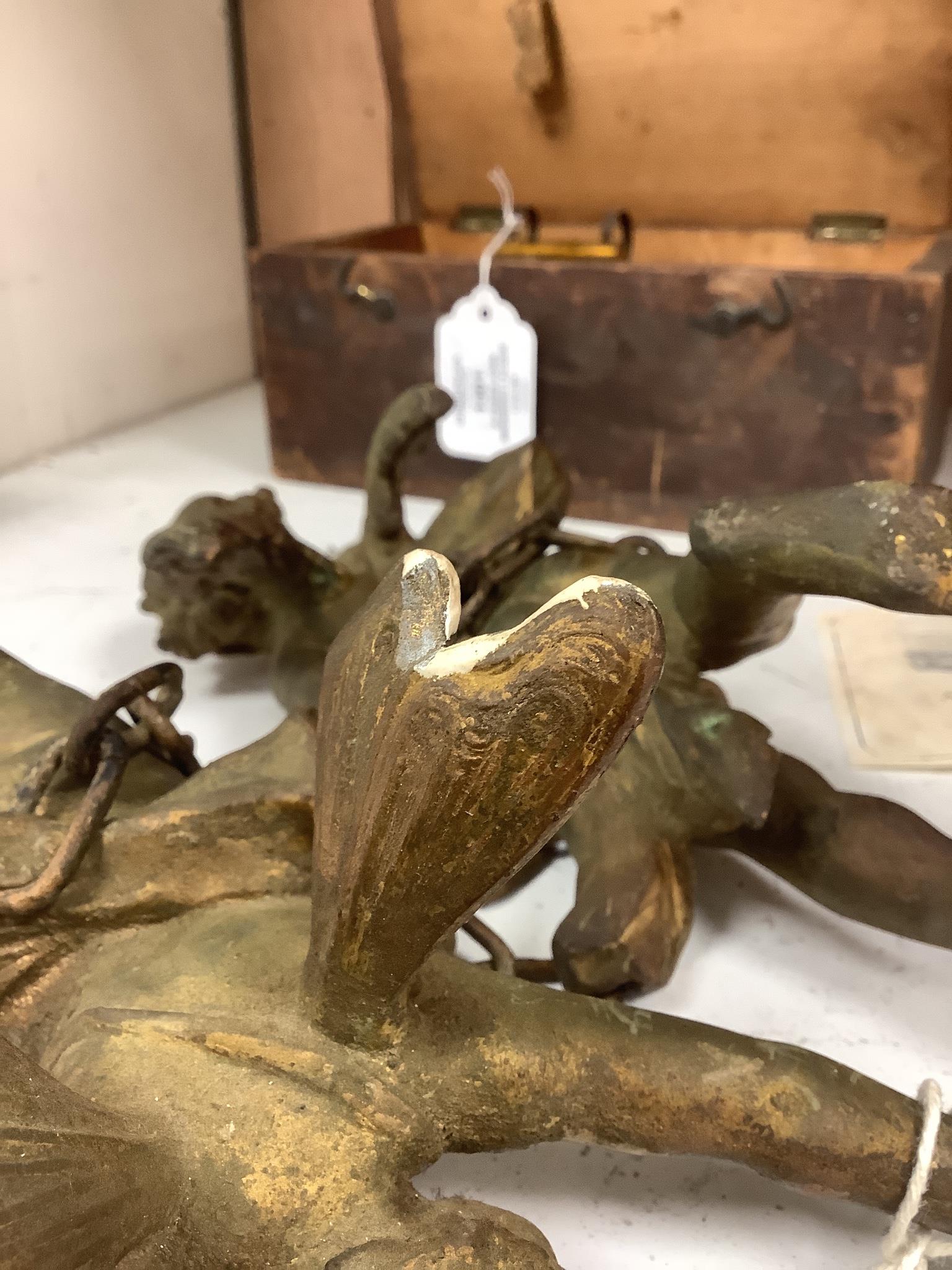 A pair of gilt metal cherub hanging figures, 26cm